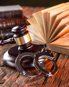 Wooden gavel and books on wooden table, law concept